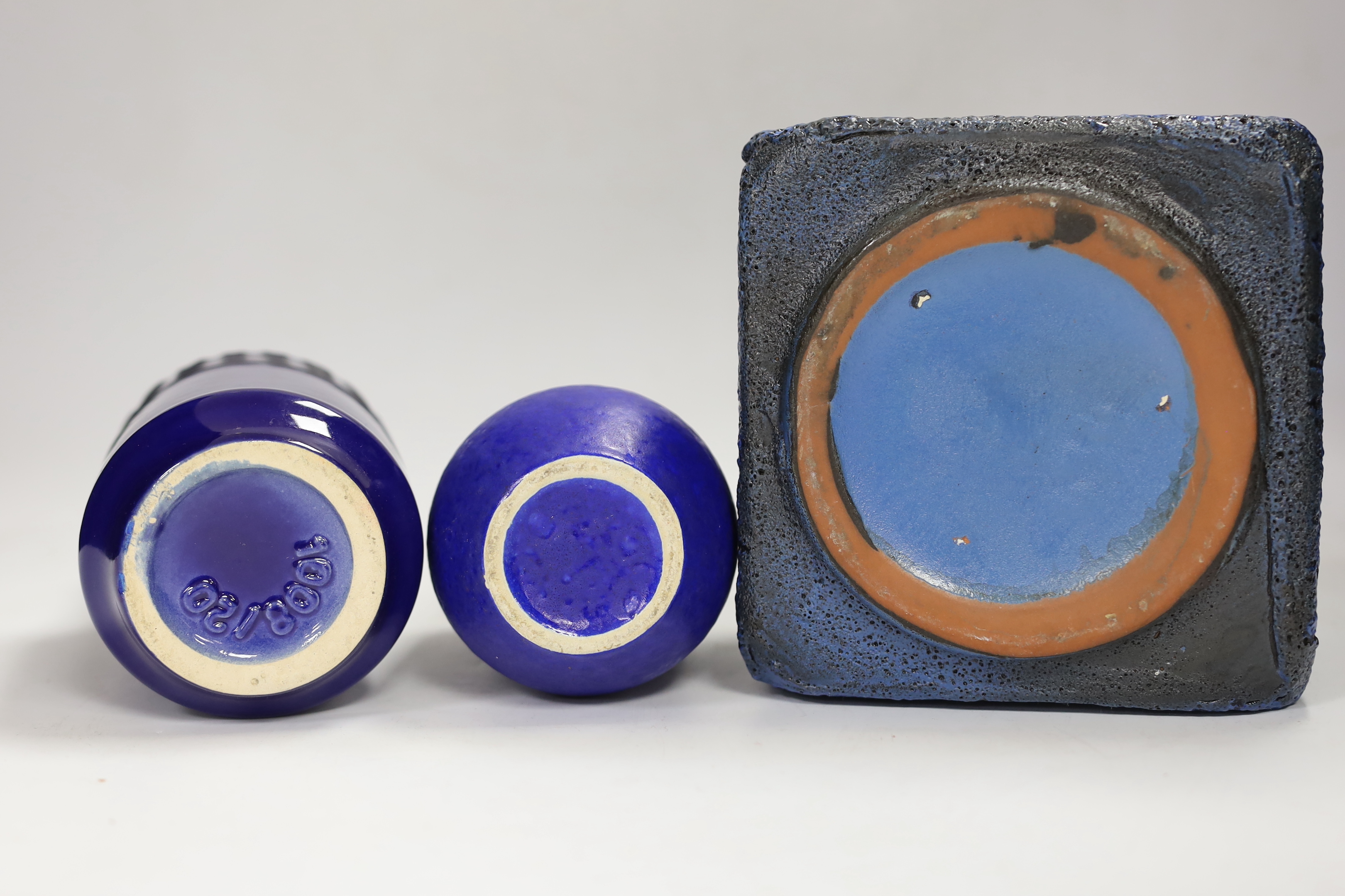 Three West German pottery vases in blue ground, one with lava glaze, tallest 22cm